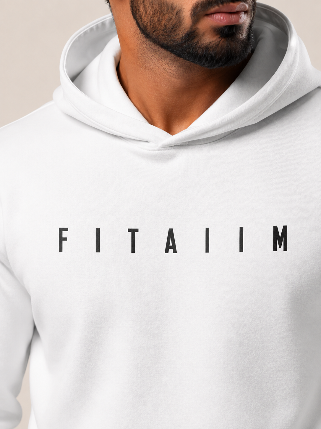 A close-up of a man wearing a white pullover hoodie with the name 'FITAIIM' printed in black capital letters across the chest.