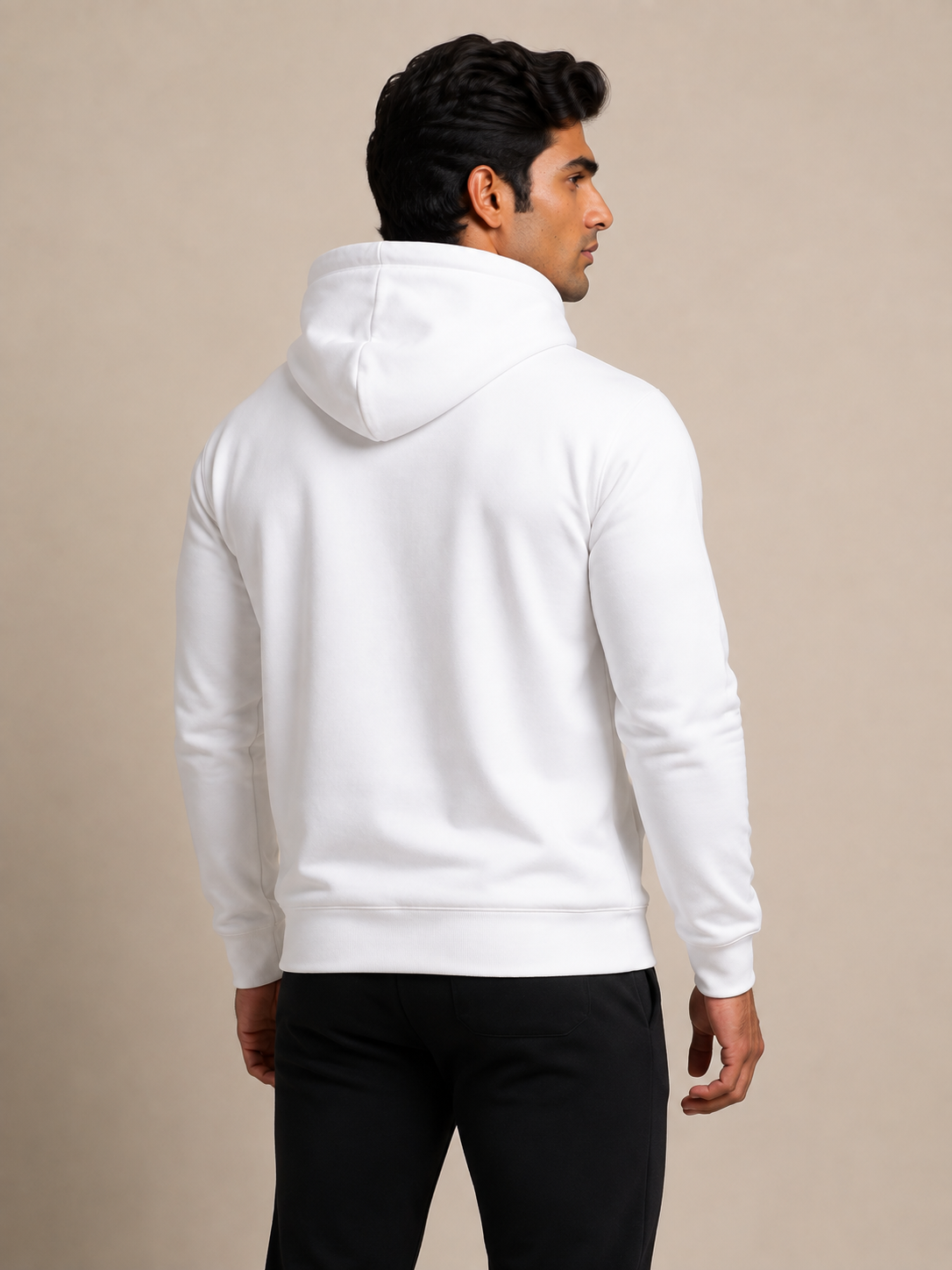 A man wearing a plain white pullover hoodie, shown from the back and side against a solid beige studio background.