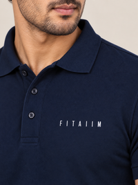 A close-up of a man wearing A NEAVY BLUE short-sleeve polo shirt with the brand name 'FITAIIM' printed in white capital letters on the left chest.