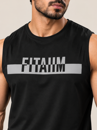 A close-up of a man wearing a black sleeveless muscle tank top with a bold gray graphic across the chest reading 'FITAIIM'.